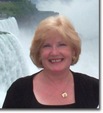 Claire Knowles standing in front of a waterfall